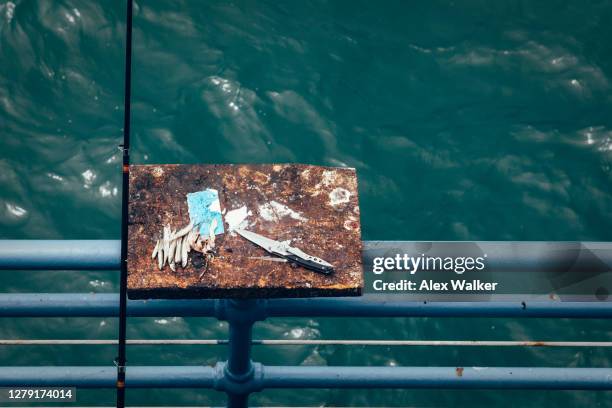 fish gutting table on railings - swiss army knife stock-fotos und bilder