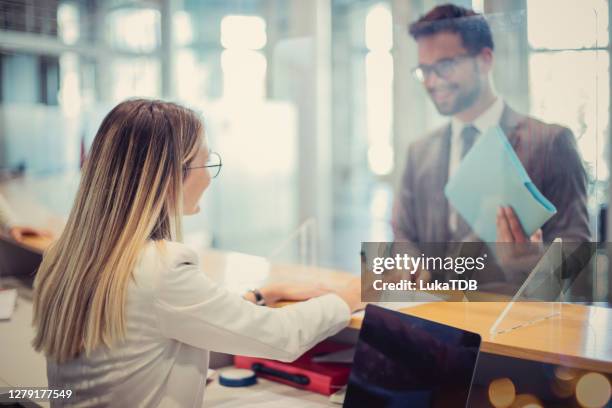 banking time - bank teller and customer stock pictures, royalty-free photos & images