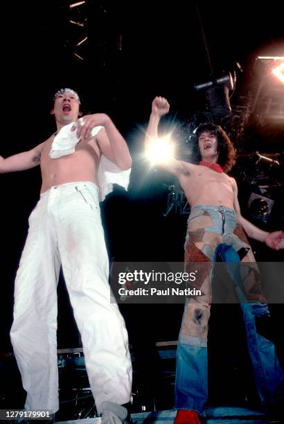 Dutch-born American brothers and Rock musicians Alex Van Halen and Eddie Van Halen , both of the group Van Halen, perform onstage at the Rosemont...