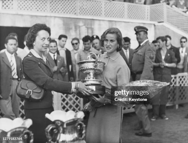 Shirley Bloomer of Great Britain receives the winner's trophy after defeating Dorothy Head Knode of the United States to win the Women's Singles...