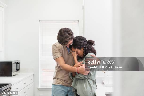 husband comforts his distraught wife - comfort stock pictures, royalty-free photos & images