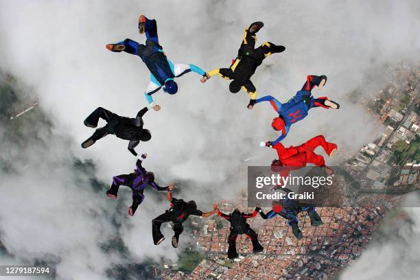 skydiving group up side down macking a star - skydiving formation stock pictures, royalty-free photos & images
