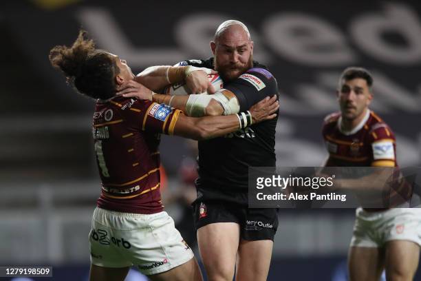Ryan Lannon of Salford Red Devils attempts to tackle Suaia Matagi of Huddersfield Giants during the Betfred Super League match between Huddersfield...