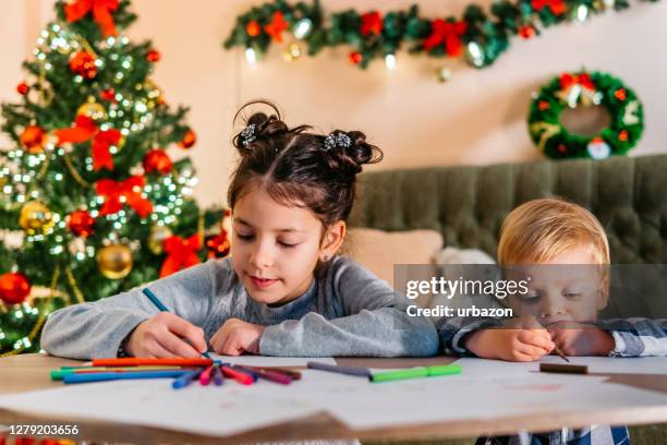 kids playing and drawing at christmas - coloring stock pictures, royalty-free photos & images
