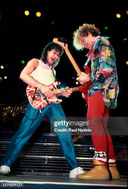 Rock musicians Sammy Hagar and Eddie Van Halen , both of the group Van Halen, perform onstage at the Metro Center, Rockford, Illinois, March 16, 1986.