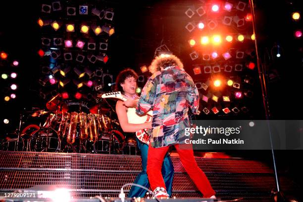 Rock musicians Sammy Hagar and Eddie Van Halen , both of the group Van Halen, perform onstage at the Metro Center, Rockford, Illinois, March 16, 1986.