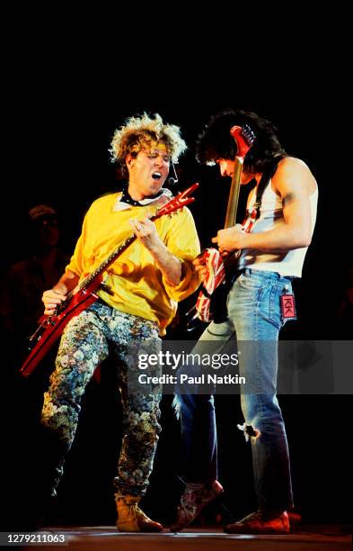 Rock musicians Eddie Van Halen and Sammy Hagar, both of the group Van Halen, perform onstage at Veteran's Stadium for the first Farm Aid benefit...
