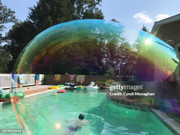 pool scene through irridescent bubbles - big bubble stock-fotos und bilder