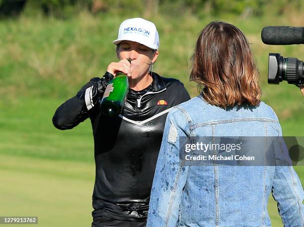 Mel Reid of England drinks champagne as she celebrates on the 18th green after winning the ShopRite LPGA Classic presented by Acer on the Bay Course...