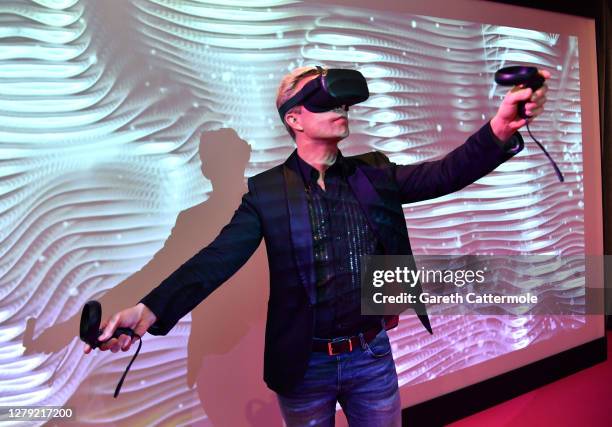 Ulrich Schrauth, London Film Festival Expanded Programmer wears a VR headset during the XR Presentation during the 64th BFI London Film Festival at...