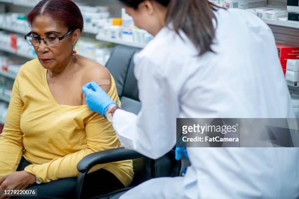 getting vaccinated - pharmacy vaccination stock pictures, royalty-free photos & images
