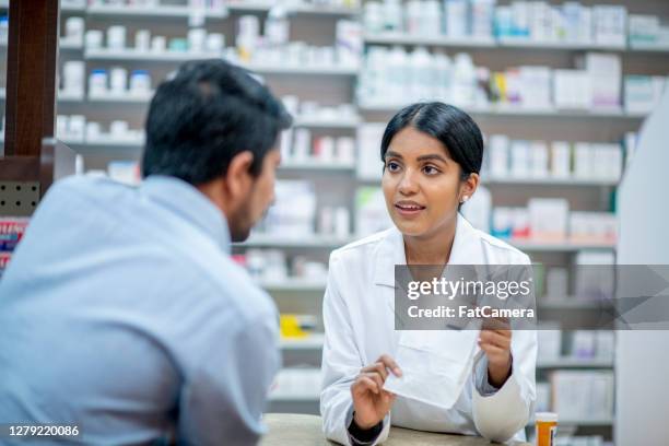 picking up prescription medicine - pharmacist and patient stock pictures, royalty-free photos & images
