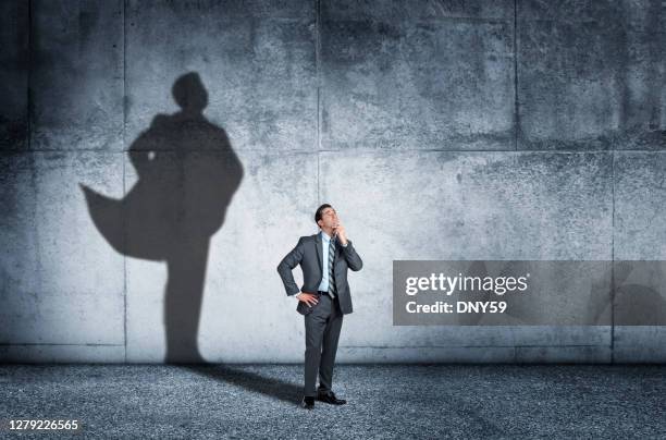 shadow of man aspiring to confidence - hero image stock pictures, royalty-free photos & images