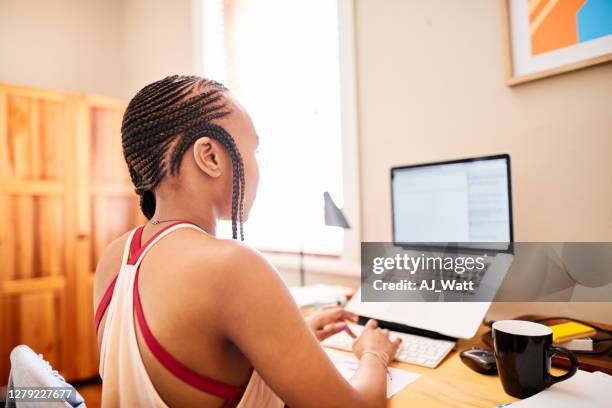 young woman working remotely using a laptop at home - cornrows stock pictures, royalty-free photos & images