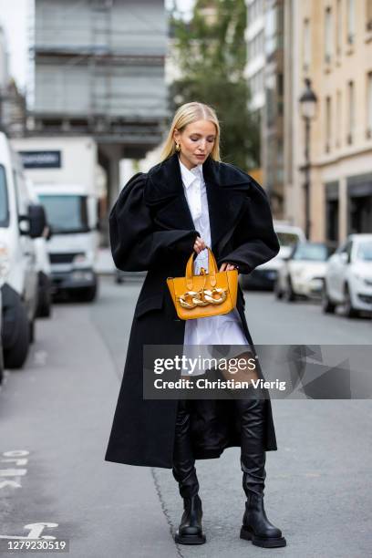 Leonie Hanne is seen wearing white J.W. Anderson blouse dress, J.W. Anderson bag, J.W. Anderson, black Bottega Veneta boots during a Street Style...