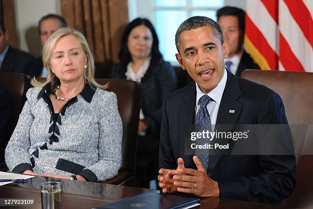 President Barack Obama speaks during a Cabinet Meeting as U.S. Secretary of State Hillary Clinton listens in the Cabinet Room October 3, 2011 at the...