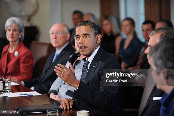 President Barack Obama speaks during a Cabinet meeting as U.S. Secretary of State Hillary Clinton listens in the Cabinet Room October 3, 2011 at the...