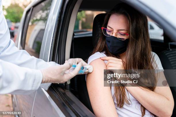 nurse performing drive-thru immunization - car studio shot stock pictures, royalty-free photos & images