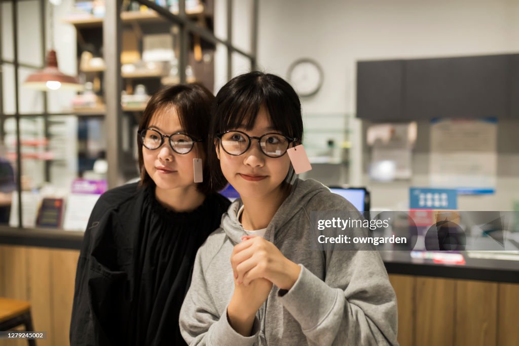 Mother and Daughter shopping for glasses at the optics