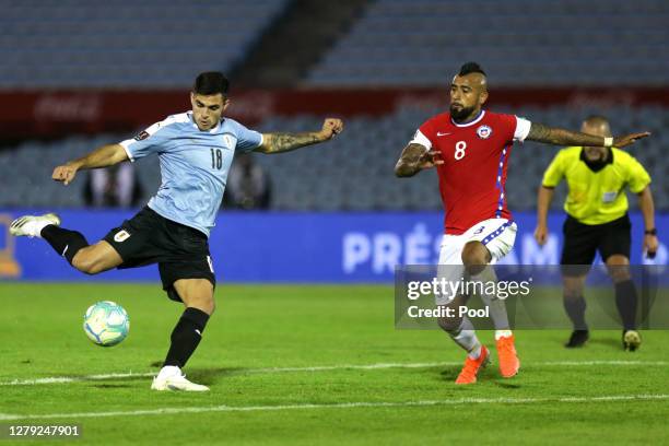 Maximiliano Gomez of Uruguay kicks the ball to score the second goal of his team during a match between Uruguay and Chile as part of South American...