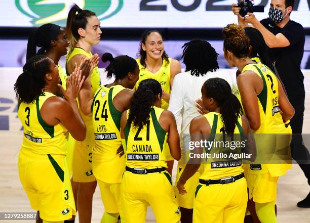 Breanna Stewart and Sue Bird of the Seattle Storm react with the team after winning the WNBA Championship following Game 3 of the WNBA Finals against...