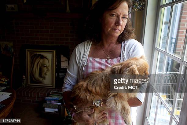 Karen Giddings, mother of slain law student Lauren Giddings, is photographed in her home with Lauren's dog "Butterbean," September 14, 2011. In the...