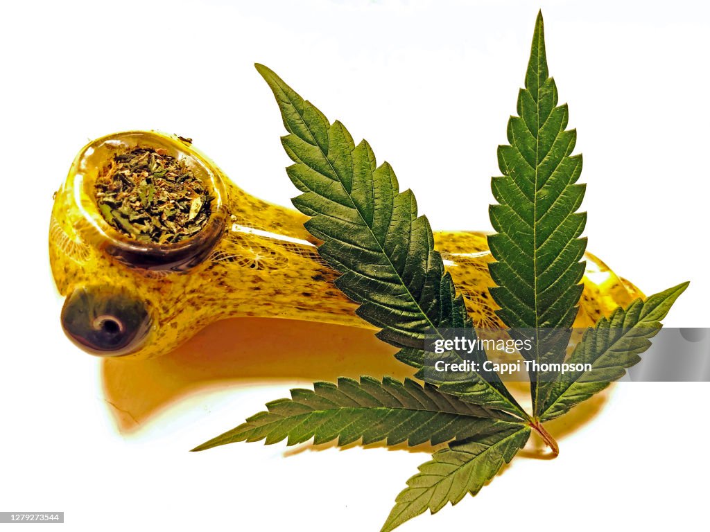 Glass Cannabis Pipe With Marijuana Leaf Over White Background High