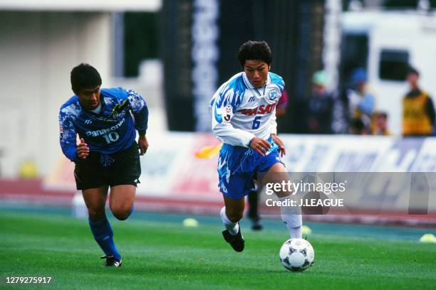 Atsuhiro Miura of Yokohama Flugels and Hiromitsu Isogai of Gamba Osaka compete for the ball during the J.League Nicos Series match between Gamba...