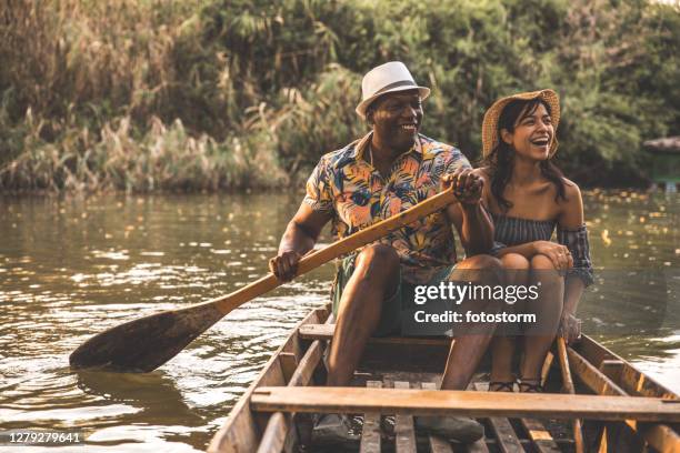 lively couple on a wooden vessel - mexican picnic stock pictures, royalty-free photos & images