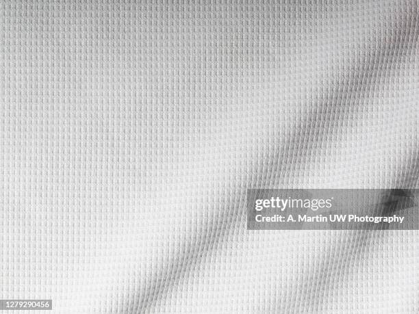 white sport shirt texture background. detail of luxury fabric surface. - tee mockup stock pictures, royalty-free photos & images