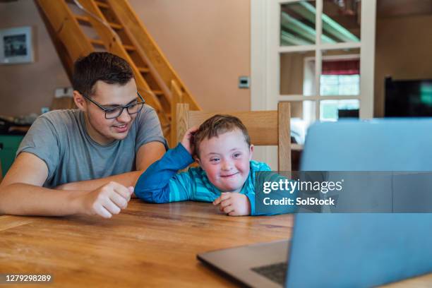 father and son video call - covid persons with disabilities stock pictures, royalty-free photos & images