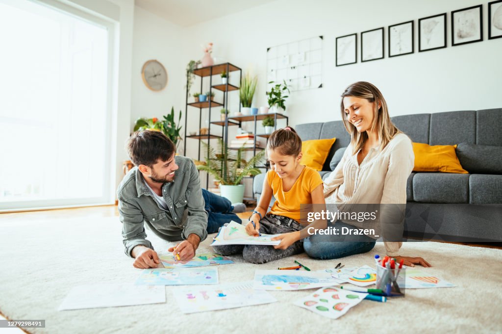 Family at home drawing with daughter