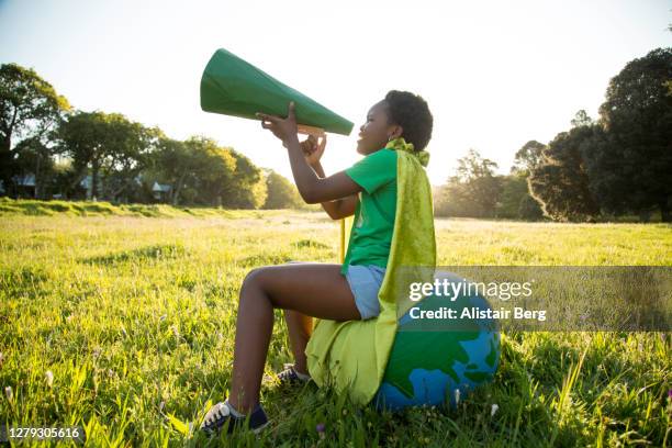 eco-warrior shouting into a megaphone - activist speech stock pictures, royalty-free photos & images