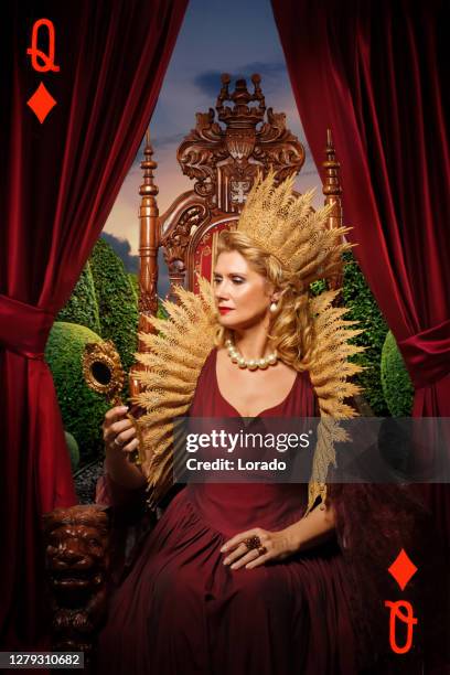 queen of hearts type character on the throne - alice stock pictures, royalty-free photos & images