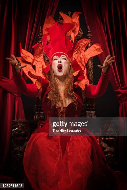 queen of hearts type character on the throne - alice by heart stock pictures, royalty-free photos & images