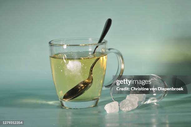 transparent glass of tea with candy sugar - sugar in glass stock pictures, royalty-free photos & images