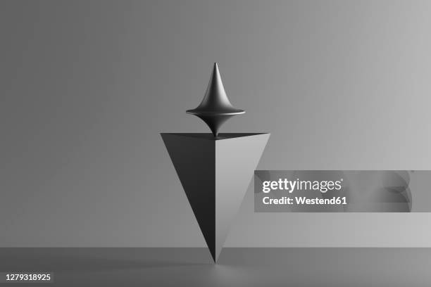 three dimensional render of metallic top spinning on top of geometric pyramid standing upside down - inverted stock illustrations