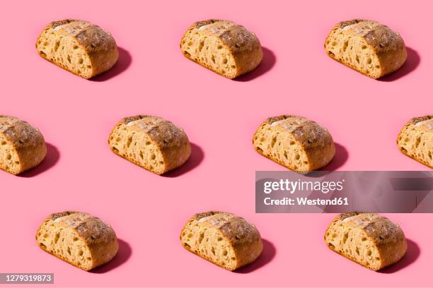 pattern of fresh loaves of bread against pink background - food stock illustrations