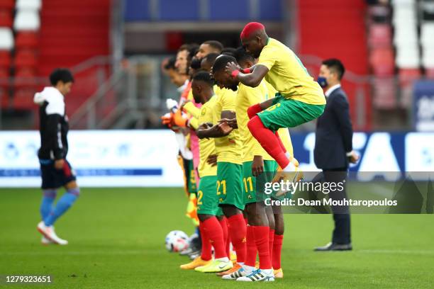 Ambroise Oyongo of Cameroon warms up as the teams line up prior to kick off during the international friendly match between Japan and Cameroon at...