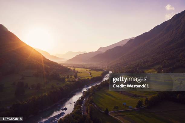 aerial view of soca river and mountains against sky during sunset at gabrje, slovenia - slovenia soca stock pictures, royalty-free photos & images