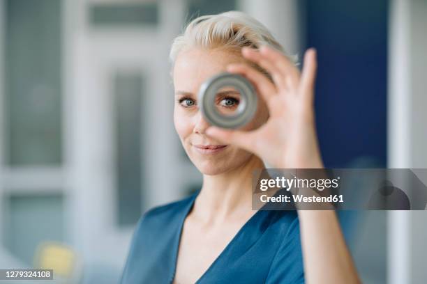 close-up of confident businesswoman looking through object in office - human hand circle stock pictures, royalty-free photos & images