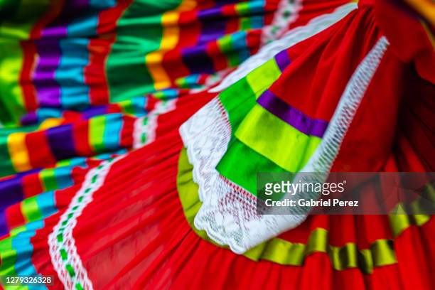 an abstract image of a traditional mexican dress in motion - folk stock-fotos und bilder
