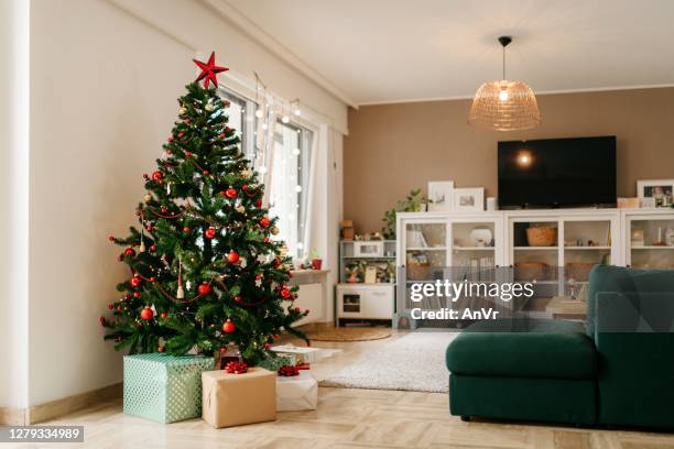 christmas tree with presents in the living room - christmas house stock pictures, royalty-free photos & images