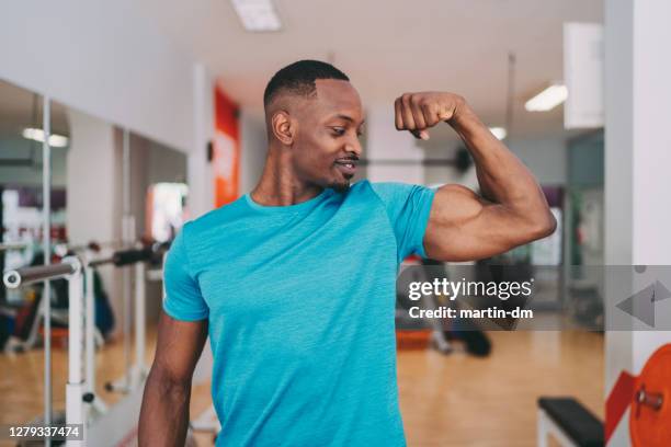 sportsman flexing biceps after workout - flexing muscles stock pictures, royalty-free photos & images