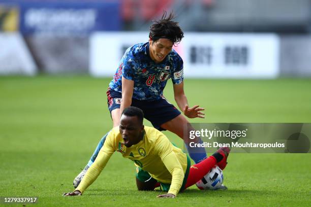 Fabrice Olinga of Cameroon is fouled by Genki Haraguchi of Japan during the international friendly match between Japan and Cameroon at Stadion...