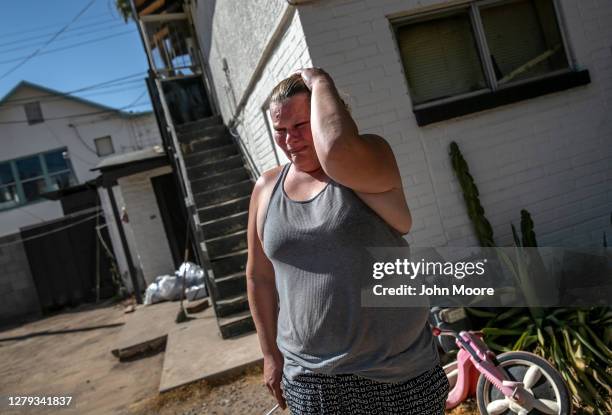 Mother is overcome with emotion after being served a court eviction order for non-payment of rent on September 30, 2020 in Phoenix, Arizona....