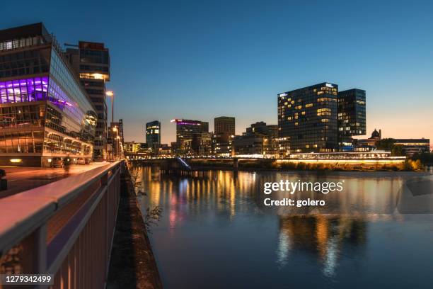 illuminated architecture in media harbour in dusseldorf at night - medienhafen stock pictures, royalty-free photos & images