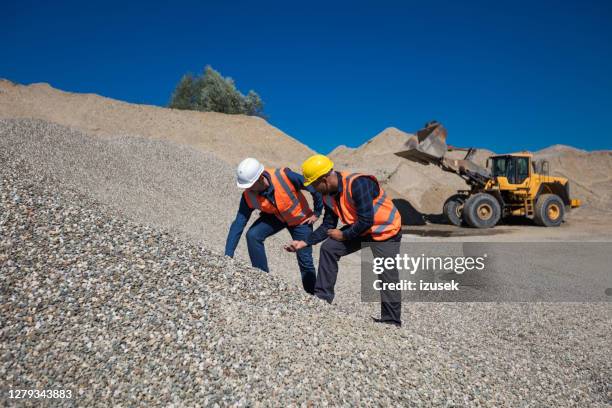 workers checking quality of gravel - granite mining quarry stock pictures, royalty-free photos & images
