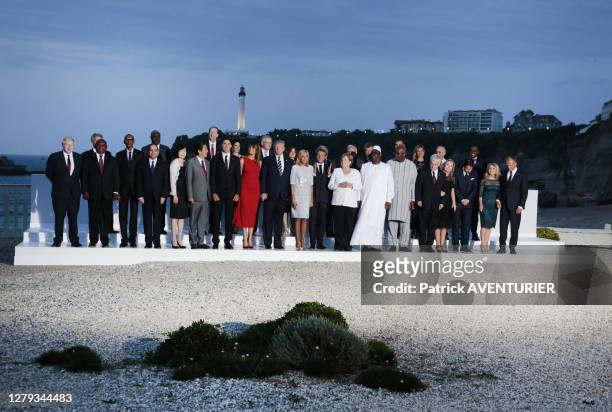 Leaders and guests pose for a family picture on the second day of the annual G7 summit in Biarritz, France, 25 August 2019, on the G7 summit. LtoR...