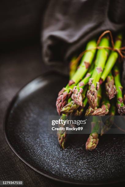 freshly picked green asparagus wrapped in dishcloth - asparagus stock pictures, royalty-free photos & images